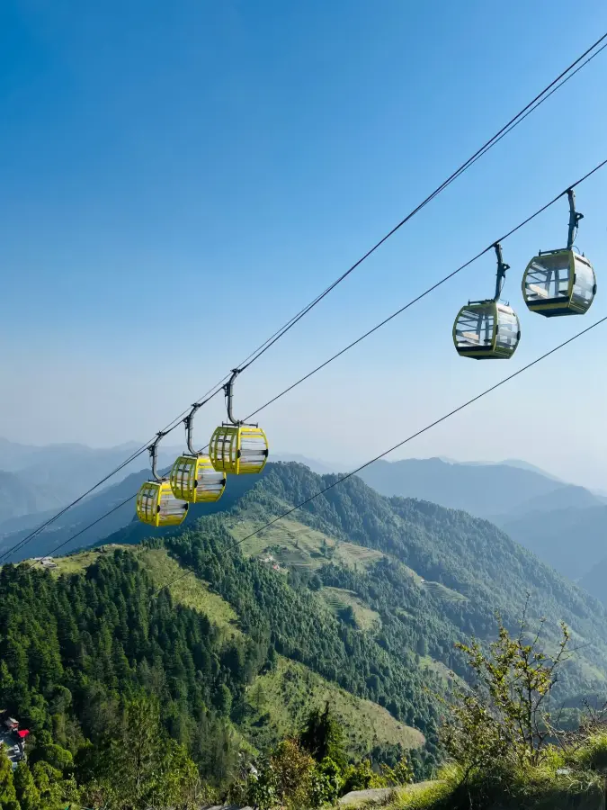 A breathtaking view of cable cars traversing the lush green mountains of Mussoorie India