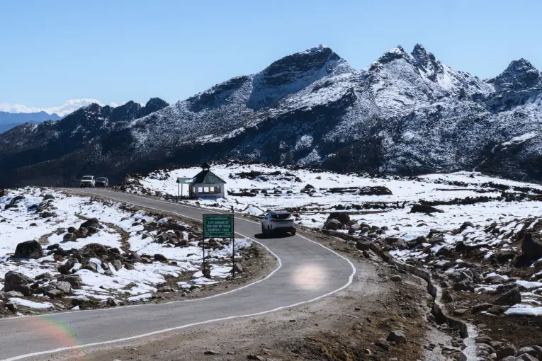 Breathtaking view of a winding road in a snowy mountainous landscape in Tawang Arunachal Pradesh