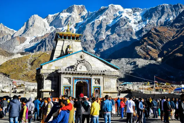 Crowd gathers at Kedarnath Temple with Himalayas backdrop Kedarnath
