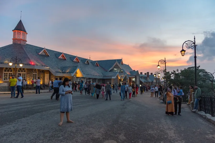 Evening scene with people near Indian landmark during sunset Shimla