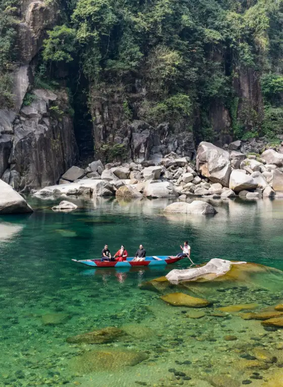 Kayakers enjoy the crystal clear waters of the Umngot River at Dawki Meghalaya India